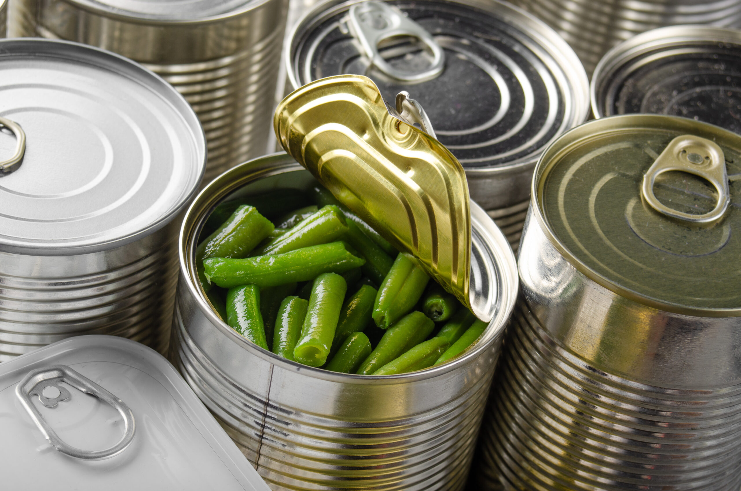 Canned green beans in just opened tin can. Non-perishable food